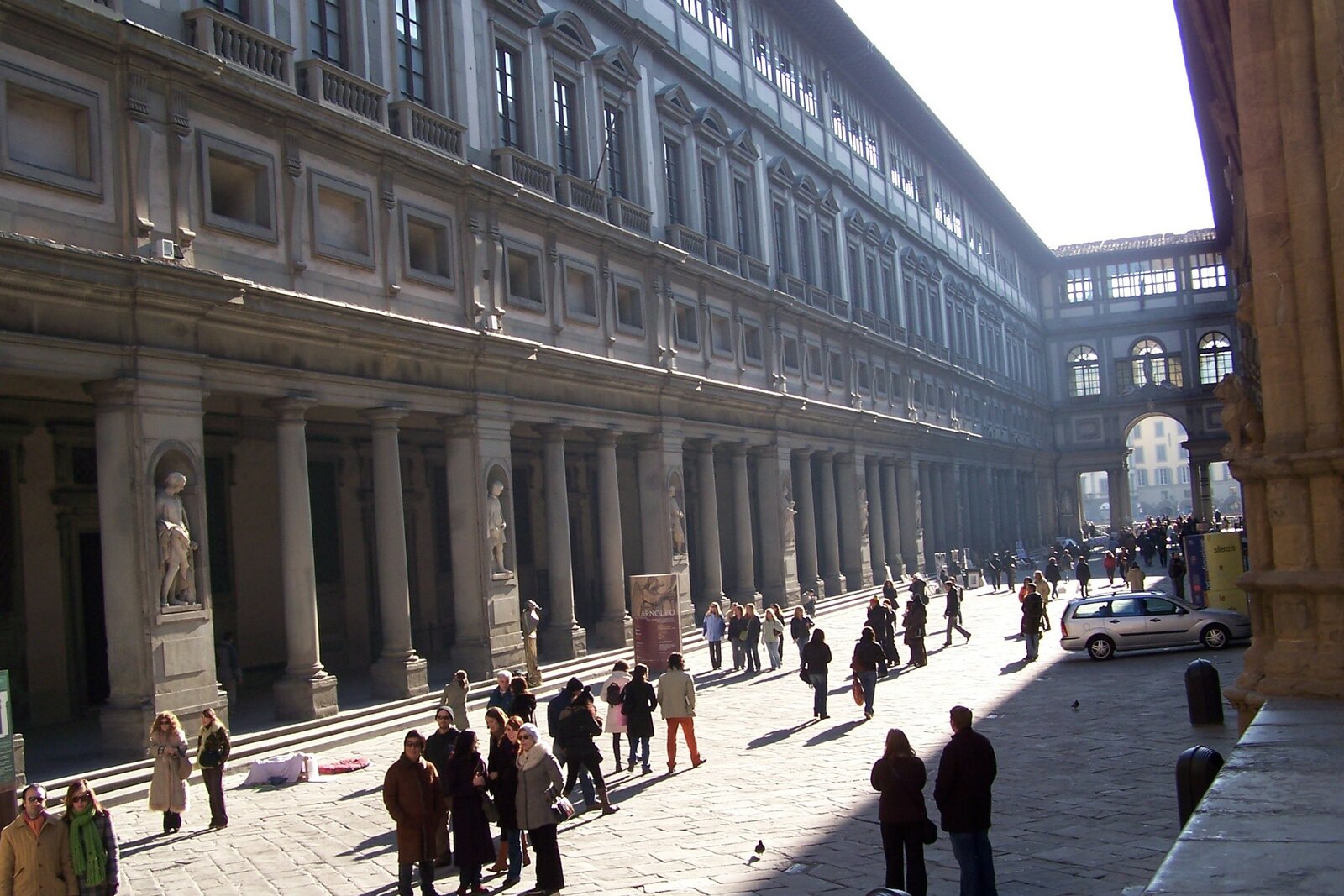 The Uffizi Courtyard with a long colonnade and a passage toward the light.