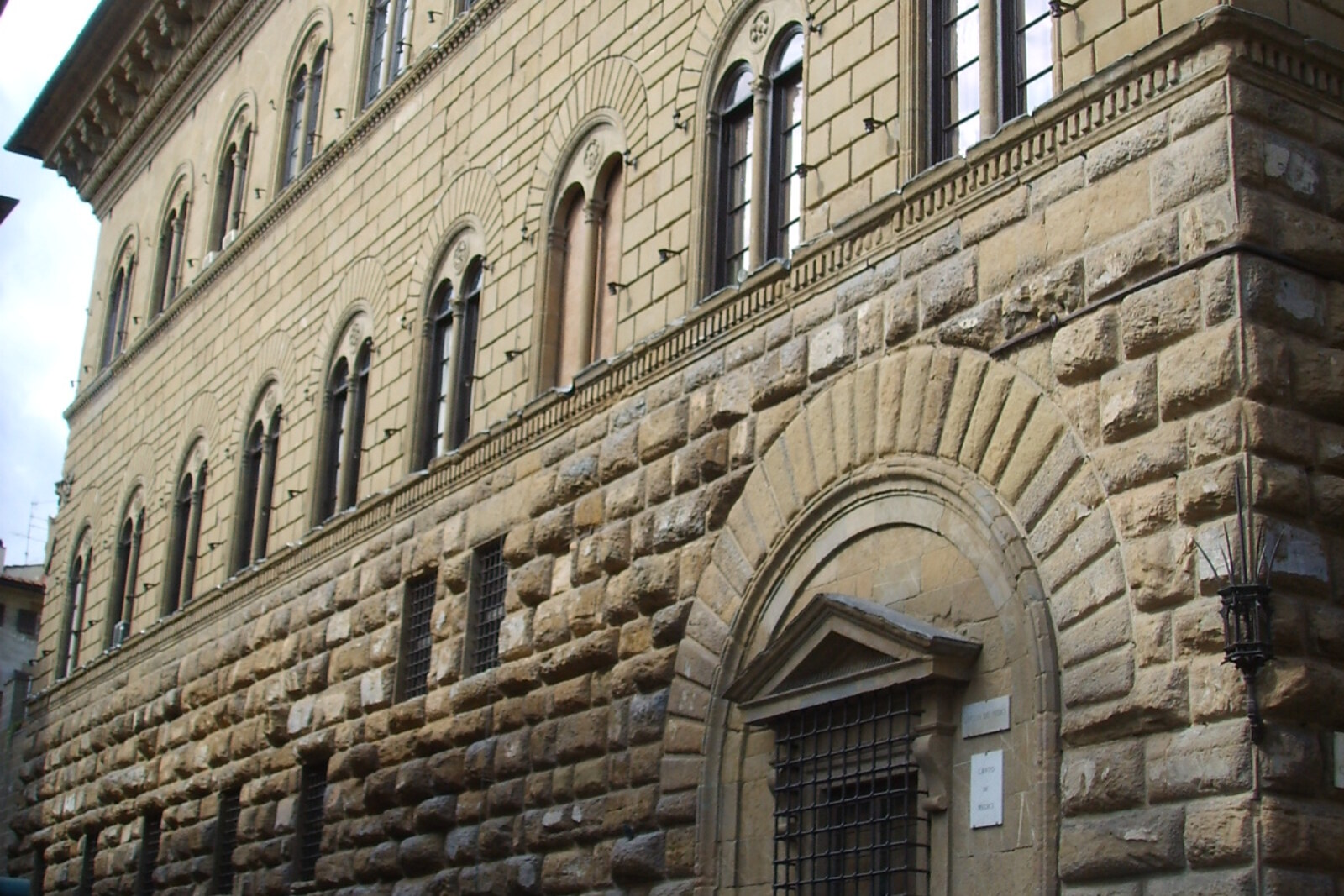 The stone facade of Palazzo Medici Riccardi, with arches and rusticated masonry.