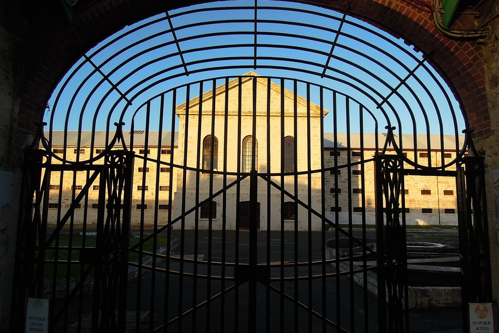 Iron gates and the main block of Fremantle Prison.