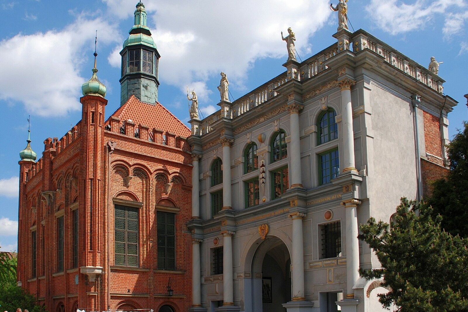 Gdańsk’s Golden Gate with three arches and figures above the facade.