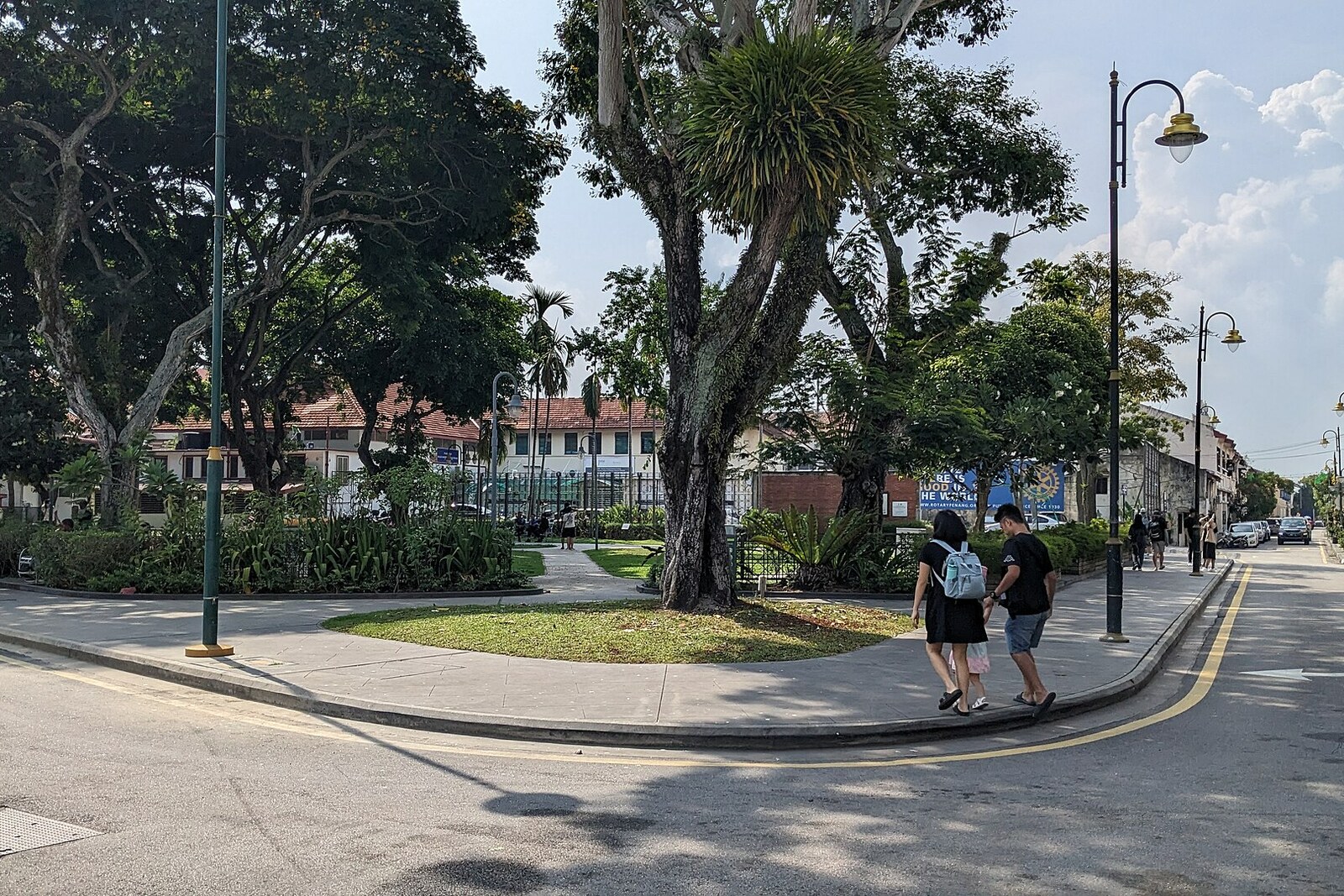 Armenian Park in George Town with green lawn, trees and surrounding shophouses.
