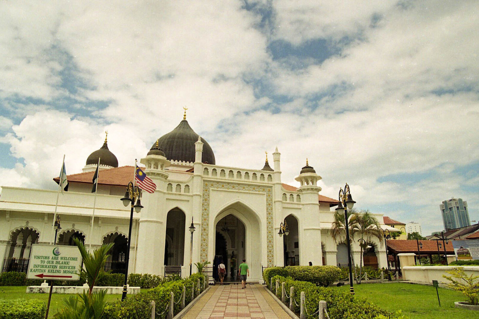 A white mosque with a black dome in George Town