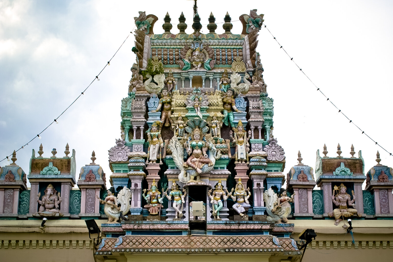 The gopuram of a Hindu temple with many small statues