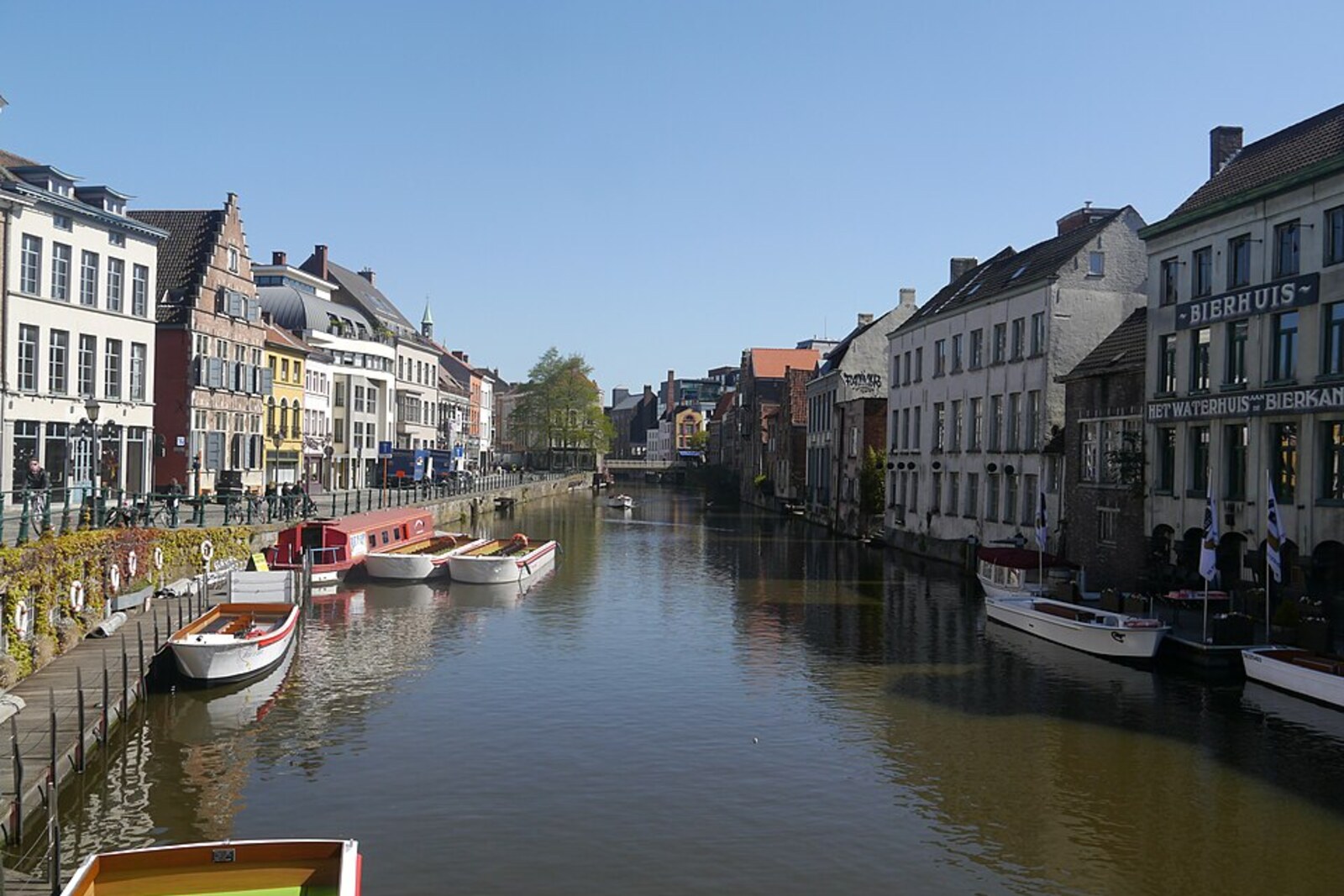 A row of narrow houses with Gothic gables along the River Lys on Kraanlei