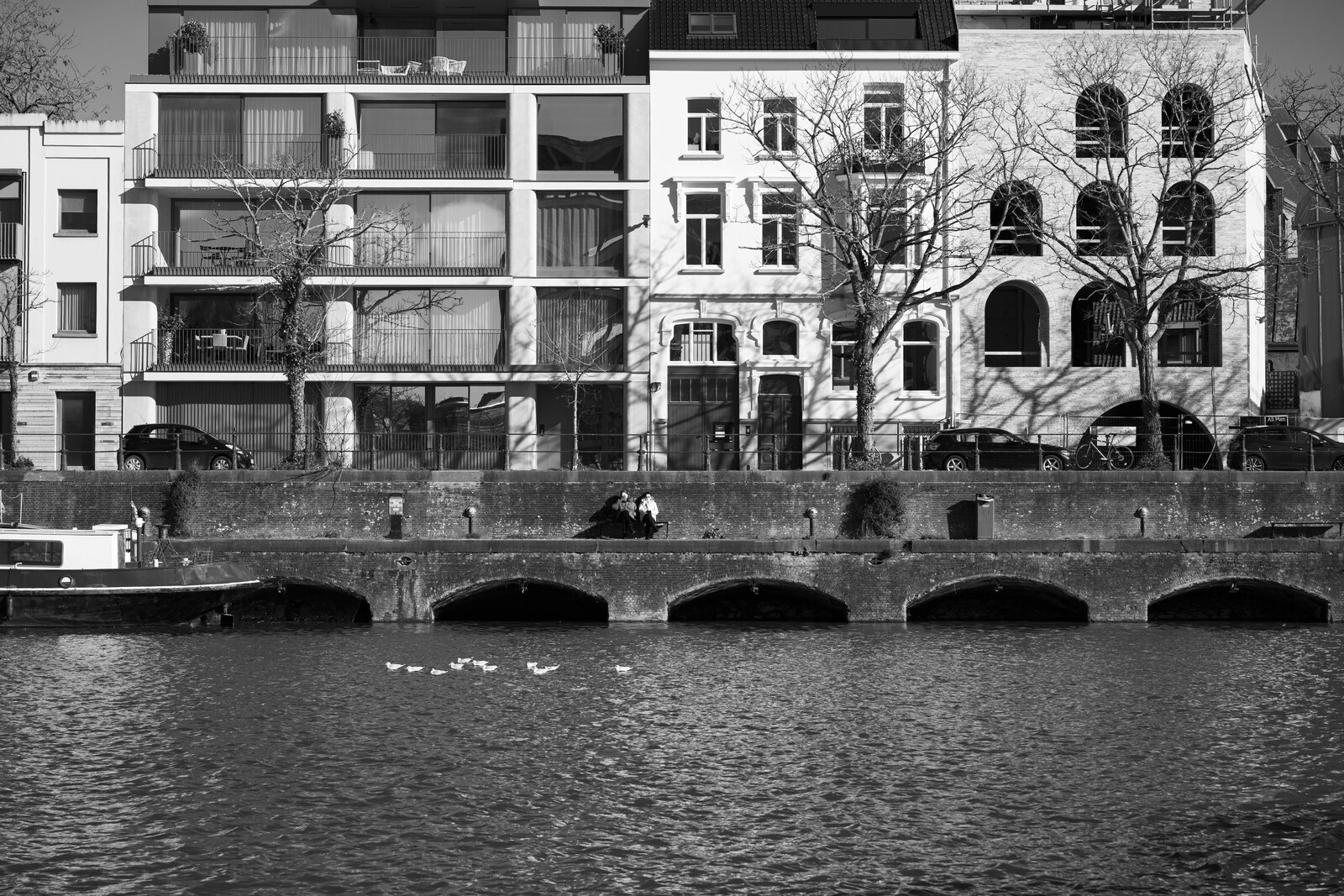 Houses and an arched bridge along the canal near Veerkaai in Ghent.