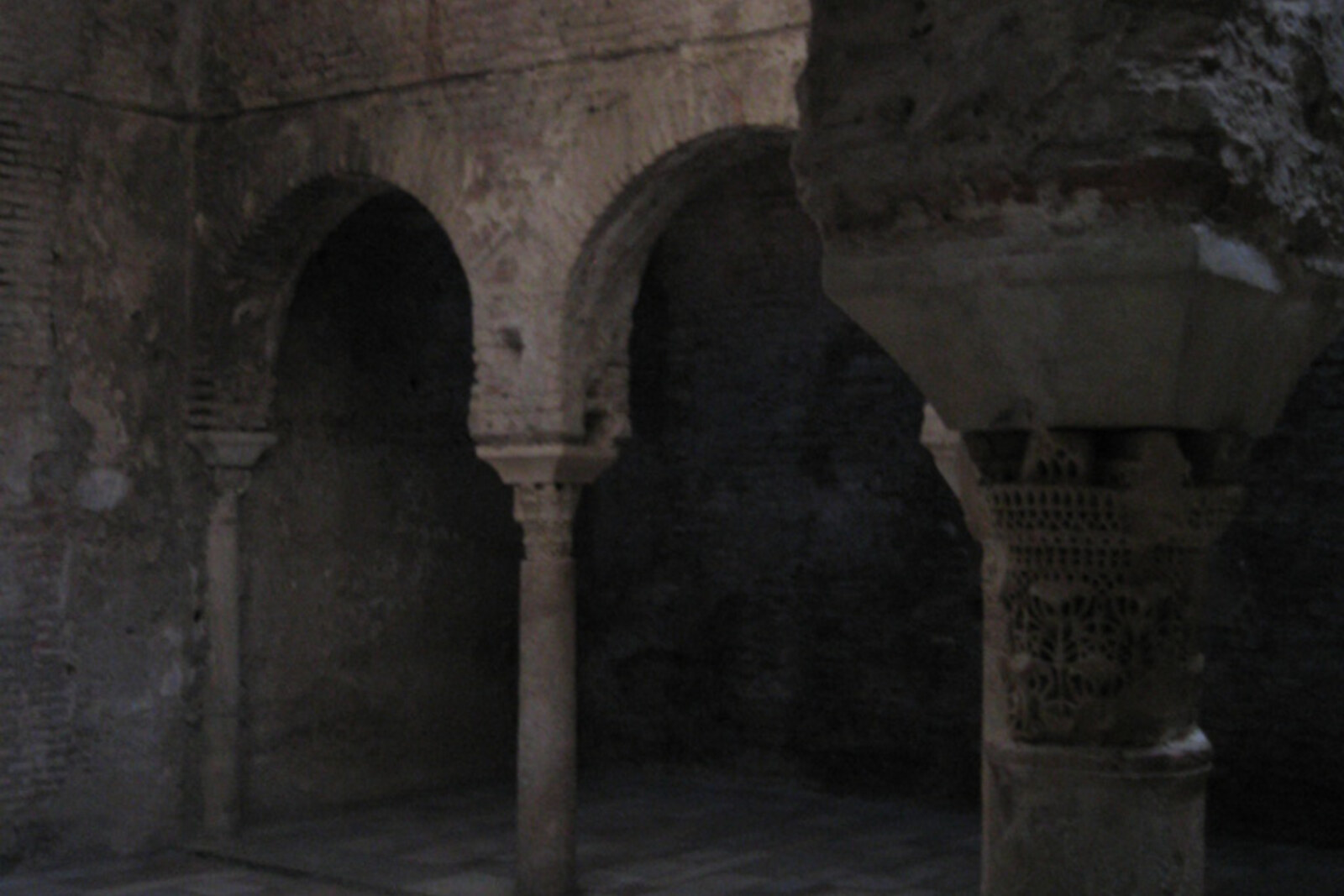 The vaulted hall of El Bañuelo, with star-shaped openings in the ceiling.