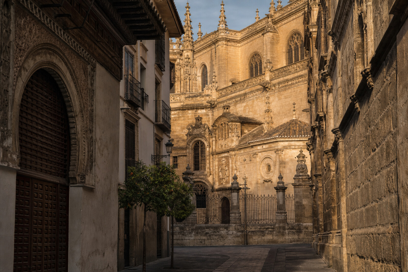 The silhouette of Granada Cathedral and the Royal Chapel of Granada above Granada's old streets on the route cover