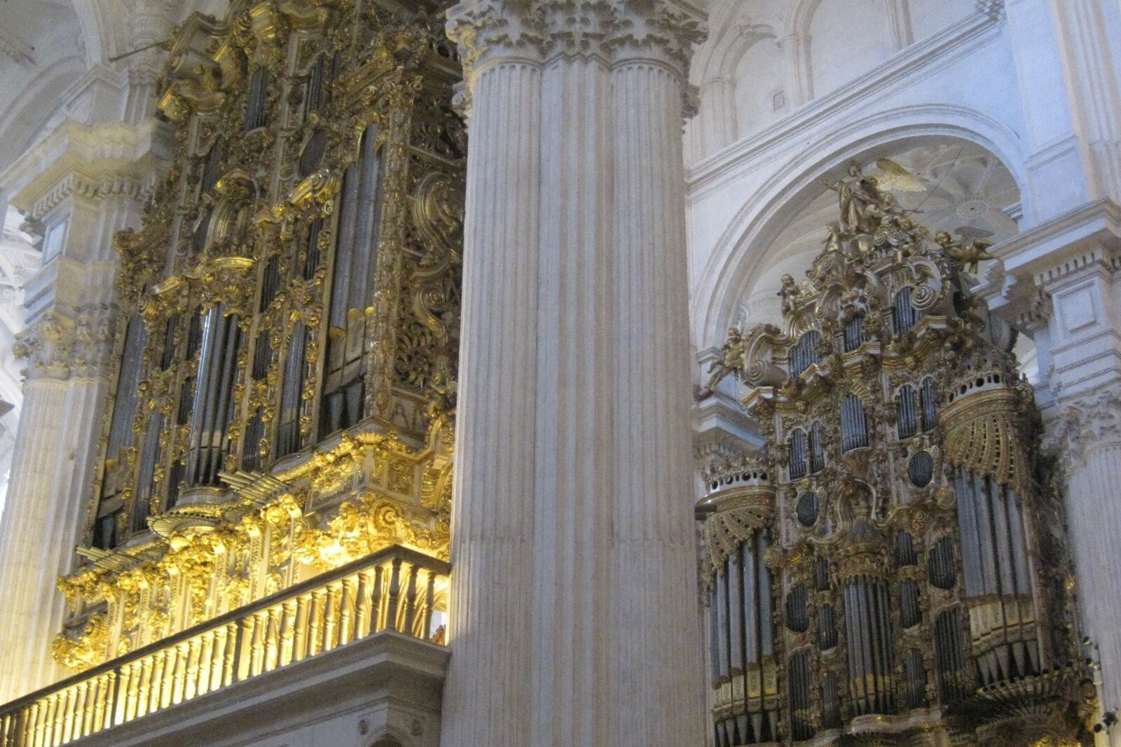 Two large organs in the interior of Granada Cathedral, lit by daylight