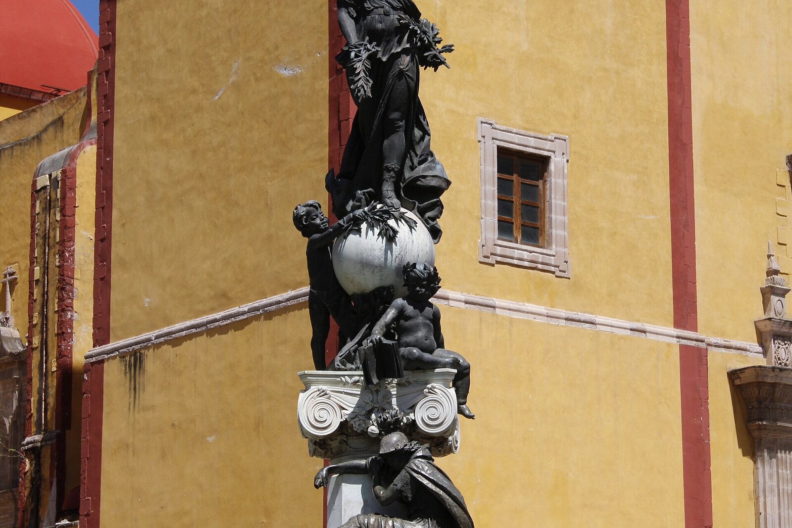 The Peace Monument in Plaza de la Paz in front of the yellow basilica.