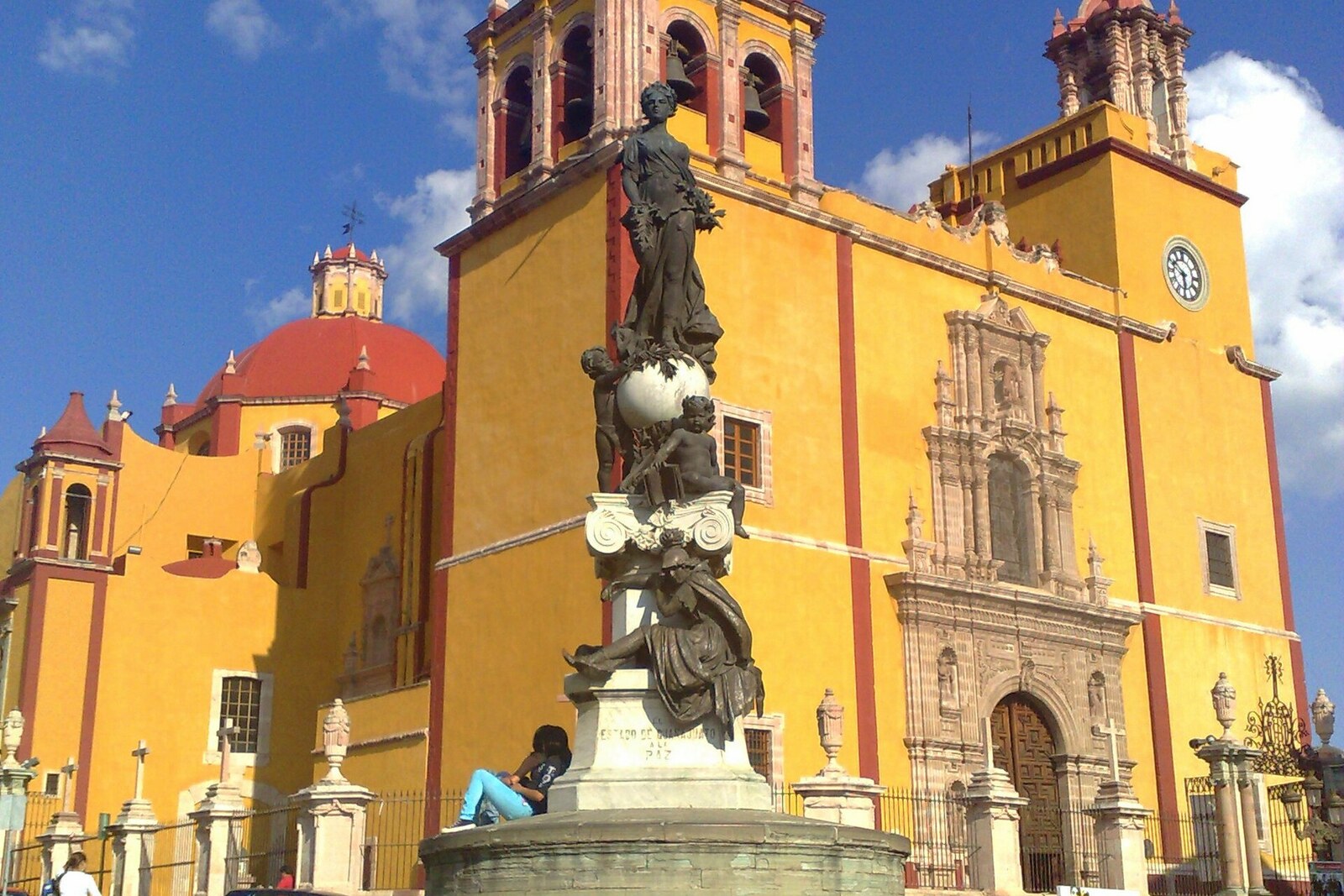 The yellow façade of the Basilica of Our Lady of Guanajuato with towers and a central portal.
