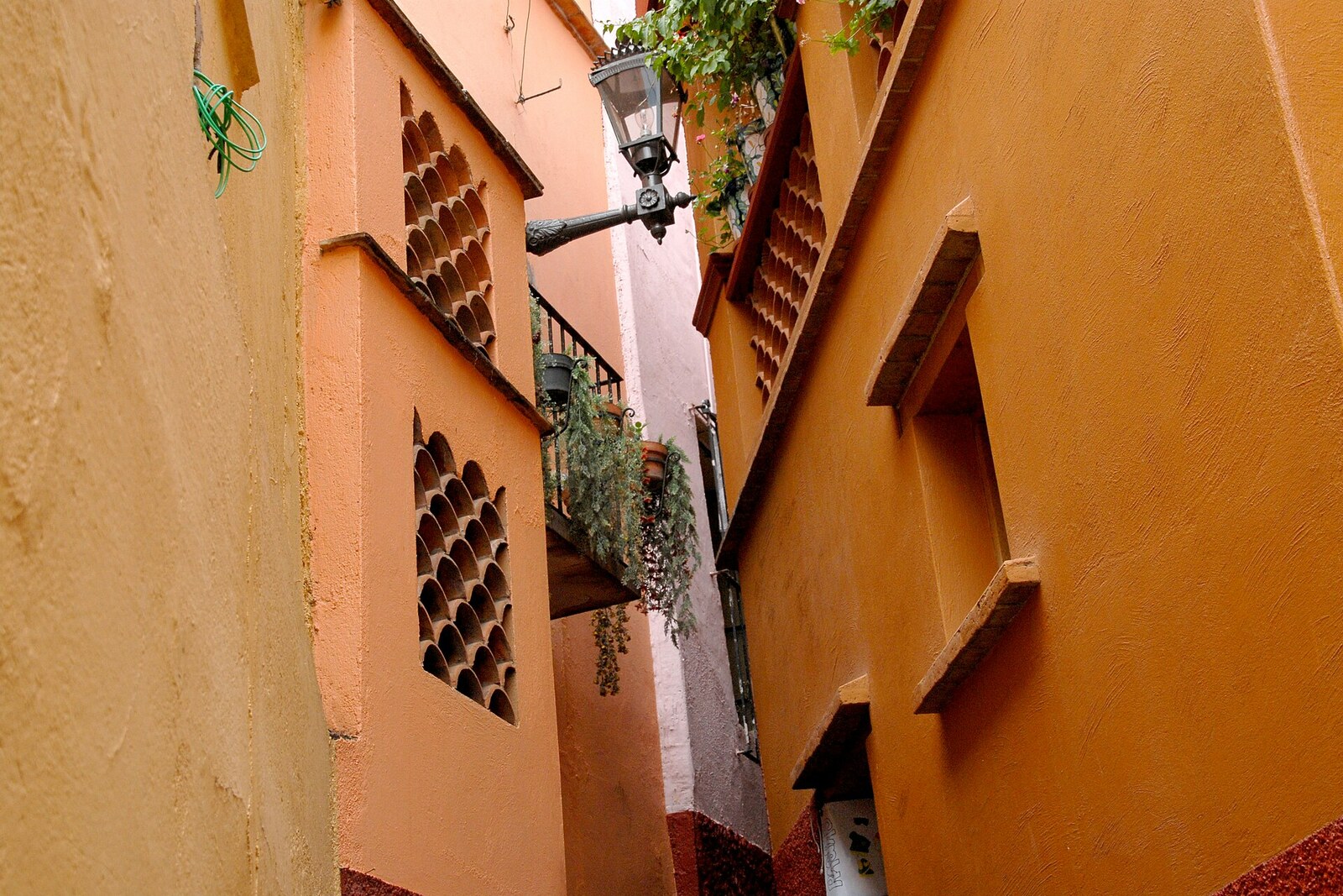 Narrow orange Alley of the Kiss with closely facing balconies.