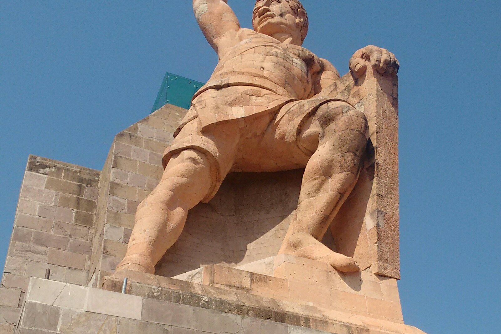 The stone monument to El Pípila with a torch on the viewing platform.