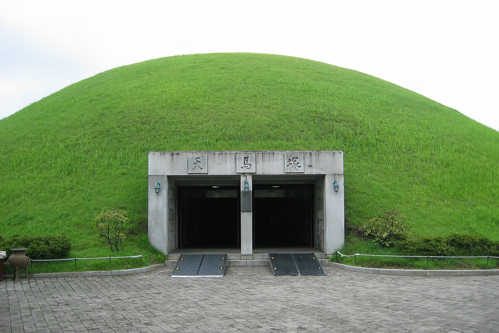 Entrance to Cheonmachong Tomb beneath a grassy mound.