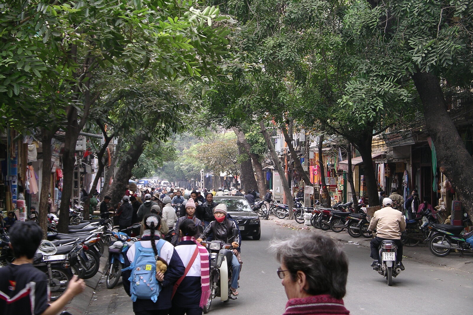 Street view of Hang Bac with a dense line of facades and the perspective of the Old Quarter.