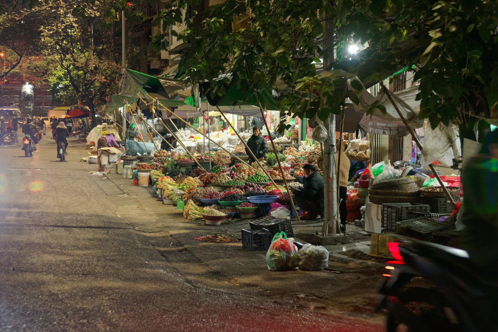A nighttime market scene in the northern part of the Hanoi Old Quarter near Dong Xuan Market.