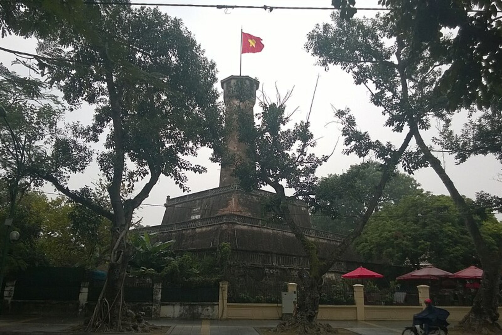 A three-tiered tower with a viewing platform and a flag flying at its summit.