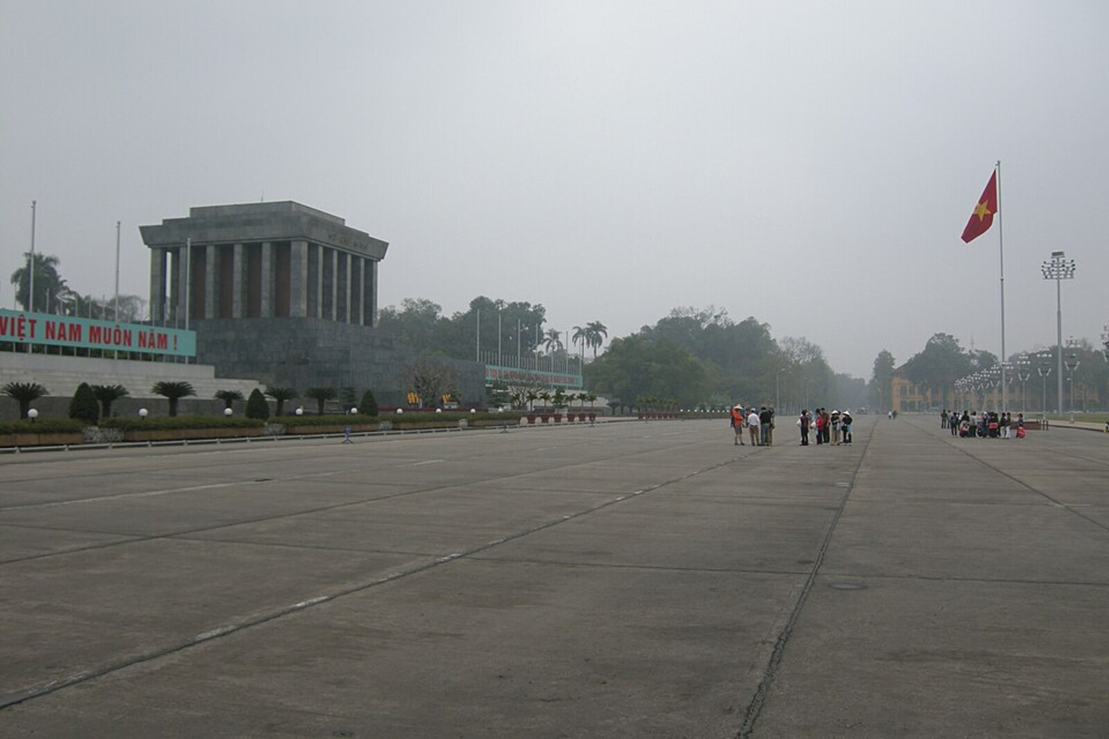 A broad green square with rectangular lawns and a granite mausoleum on the horizon.