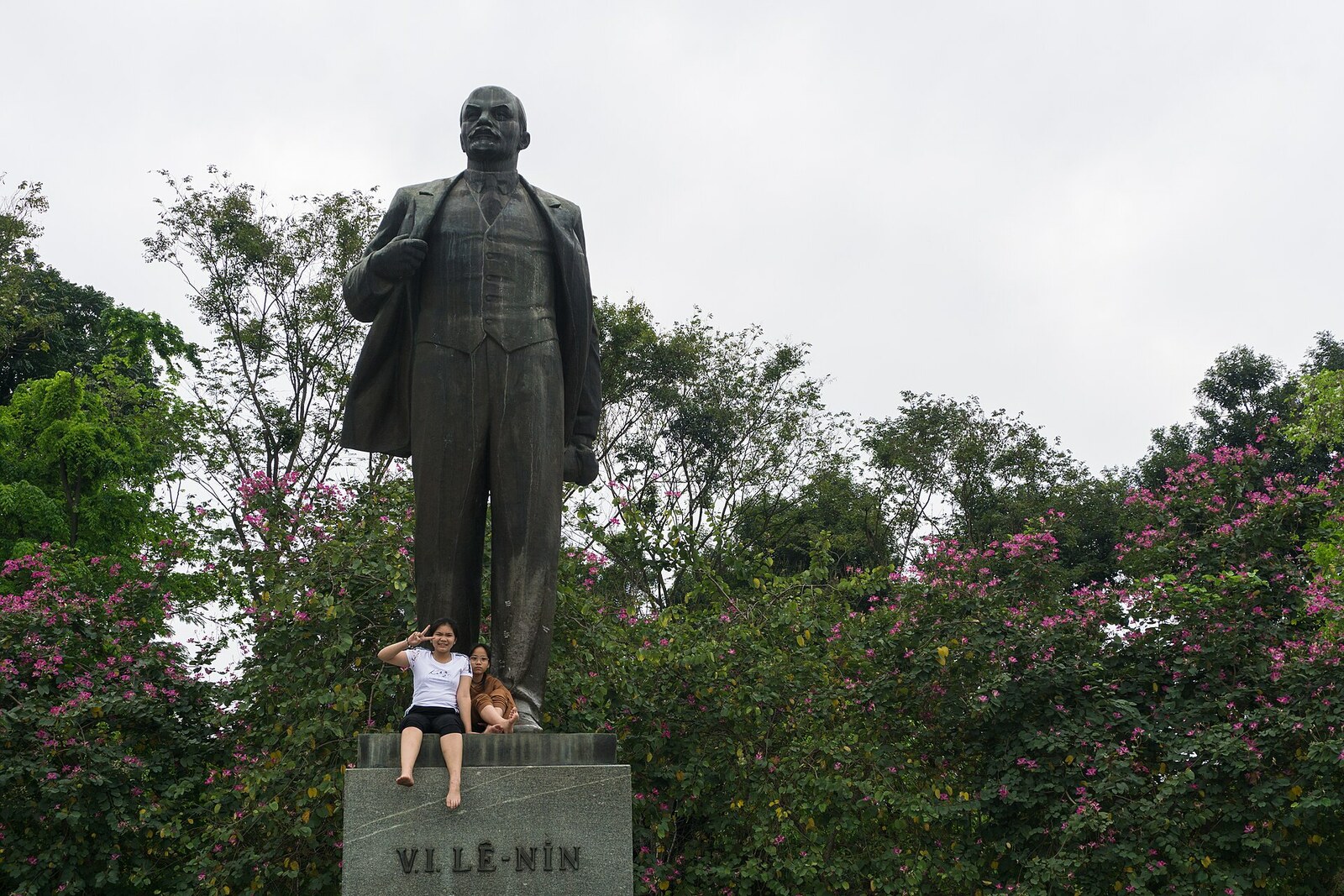 A bronze monument to Lenin in a small urban park in Hanoi.