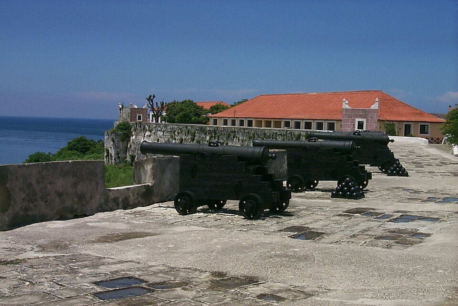 Two old cast-iron cannons on the stone bastions of Morro Castle
