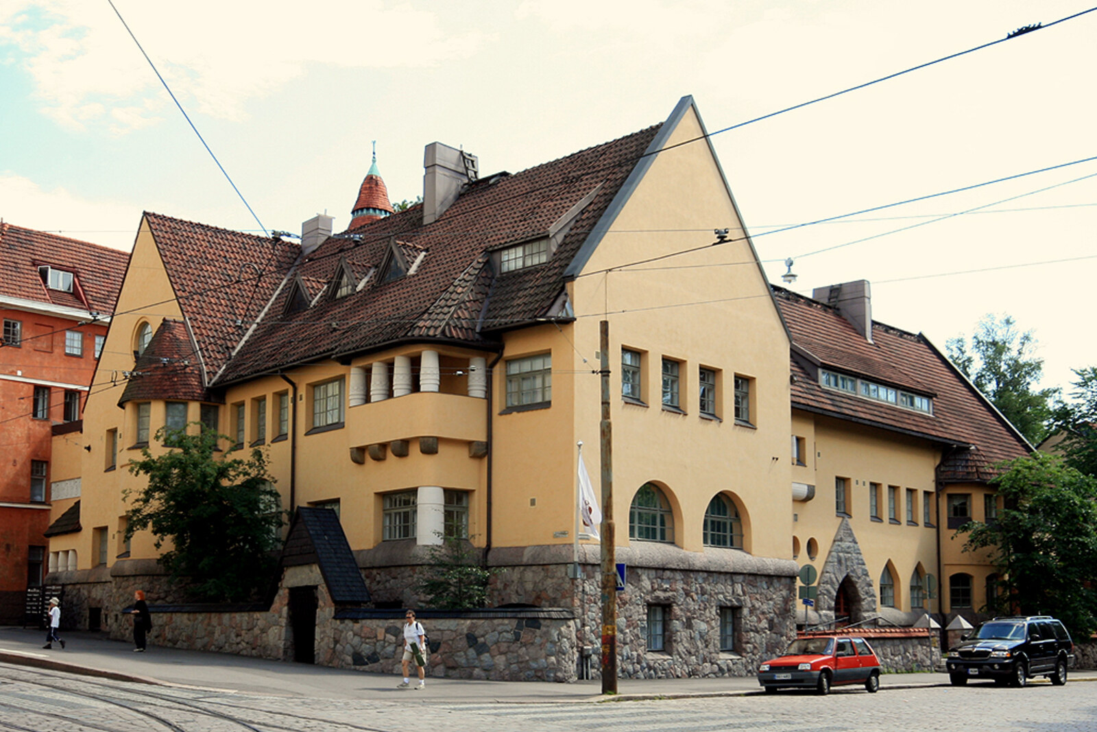 Yellow building with turrets—Eira Hospital at a street intersection