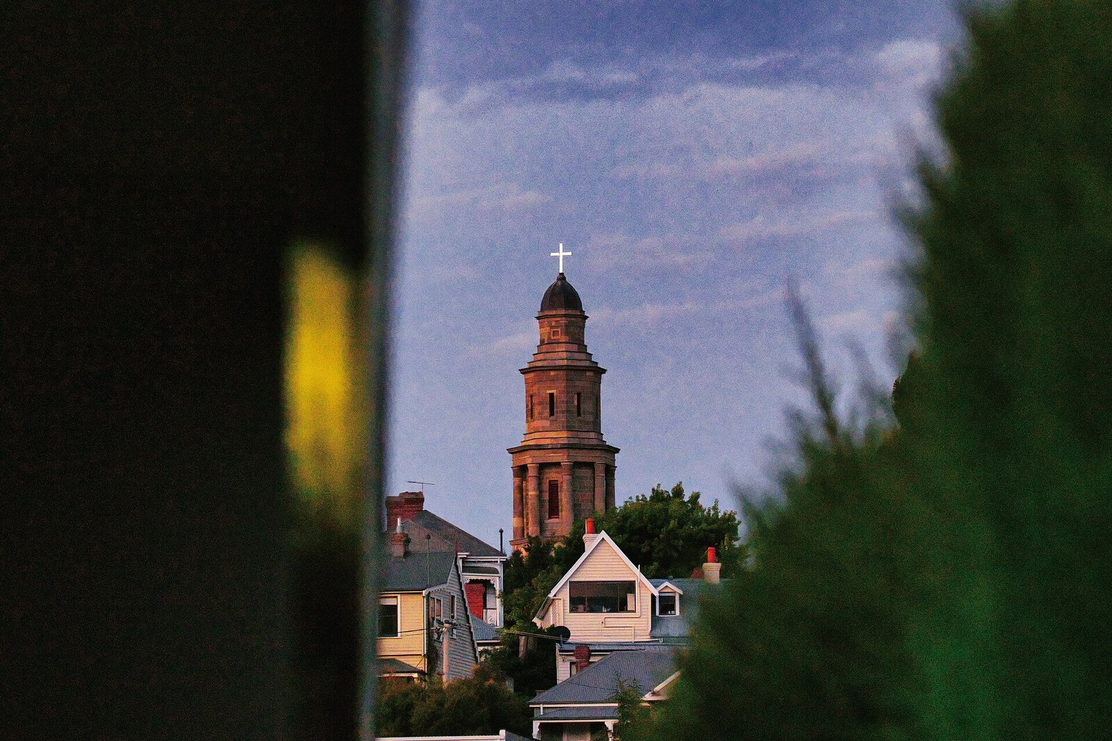 The sandstone tower of St George's Anglican Church above the roofs of Battery Point.
