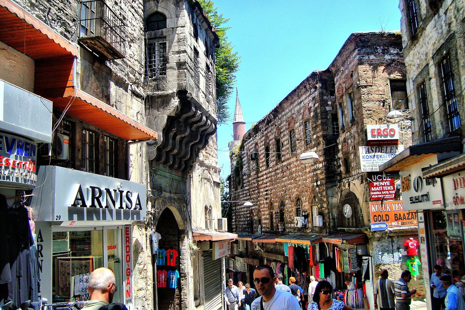 A lively narrow Tahtakale street with shops and signs