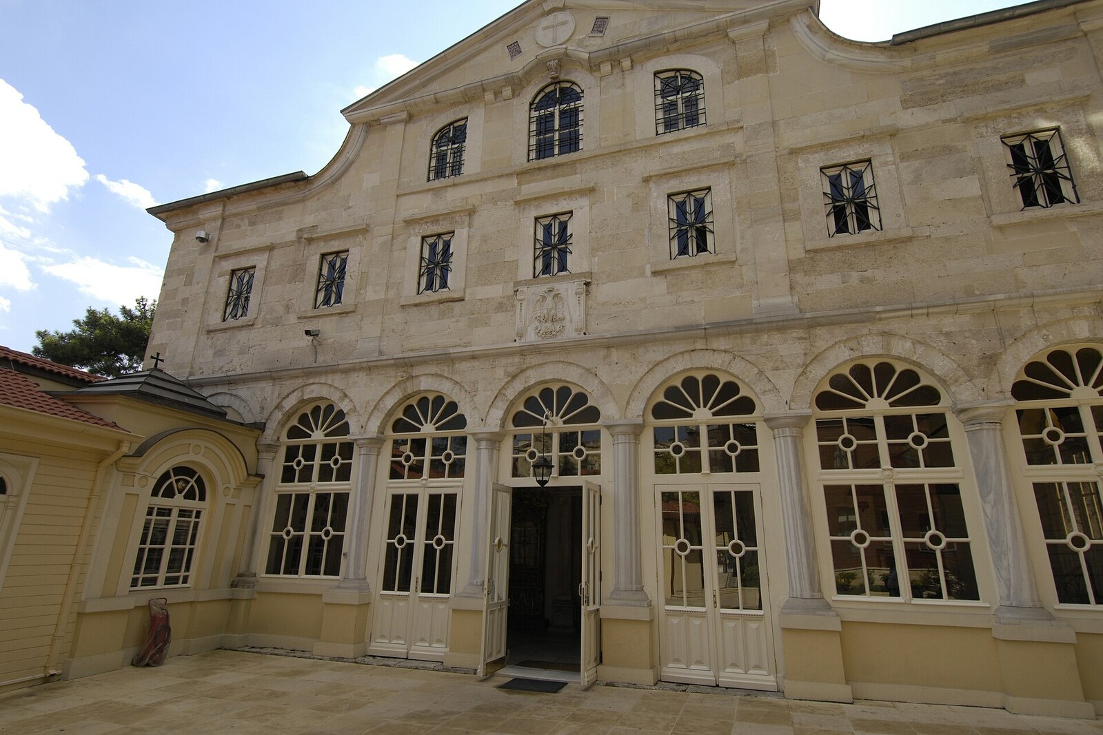 Facade of Church of St. George and the courtyard of the Ecumenical Patriarchate of Constantinople with wooden buildings
