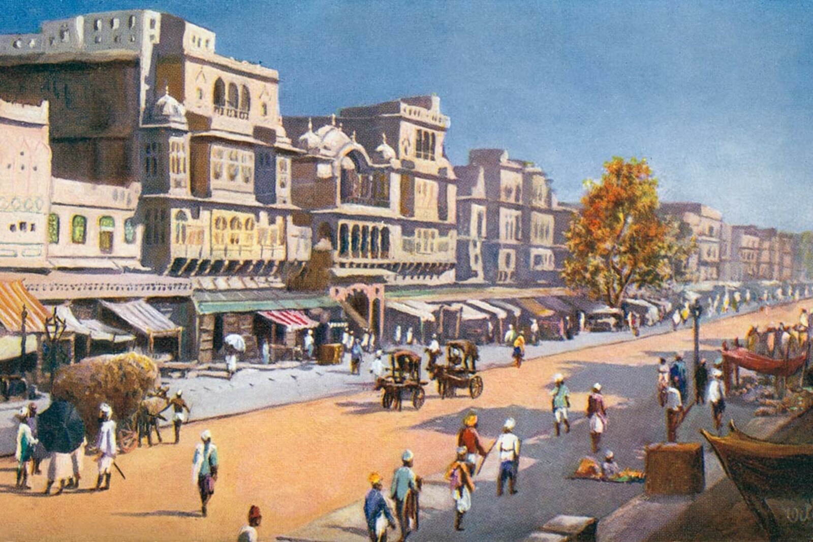 A historic street scene on Johari Bazaar in Jaipur, with shops and passersby.