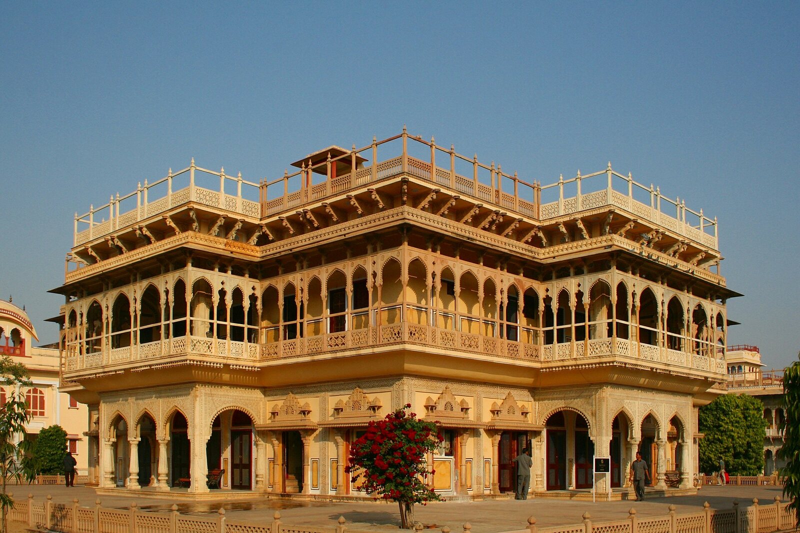 A palace building at City Palace in Jaipur, with an open courtyard in front of it.