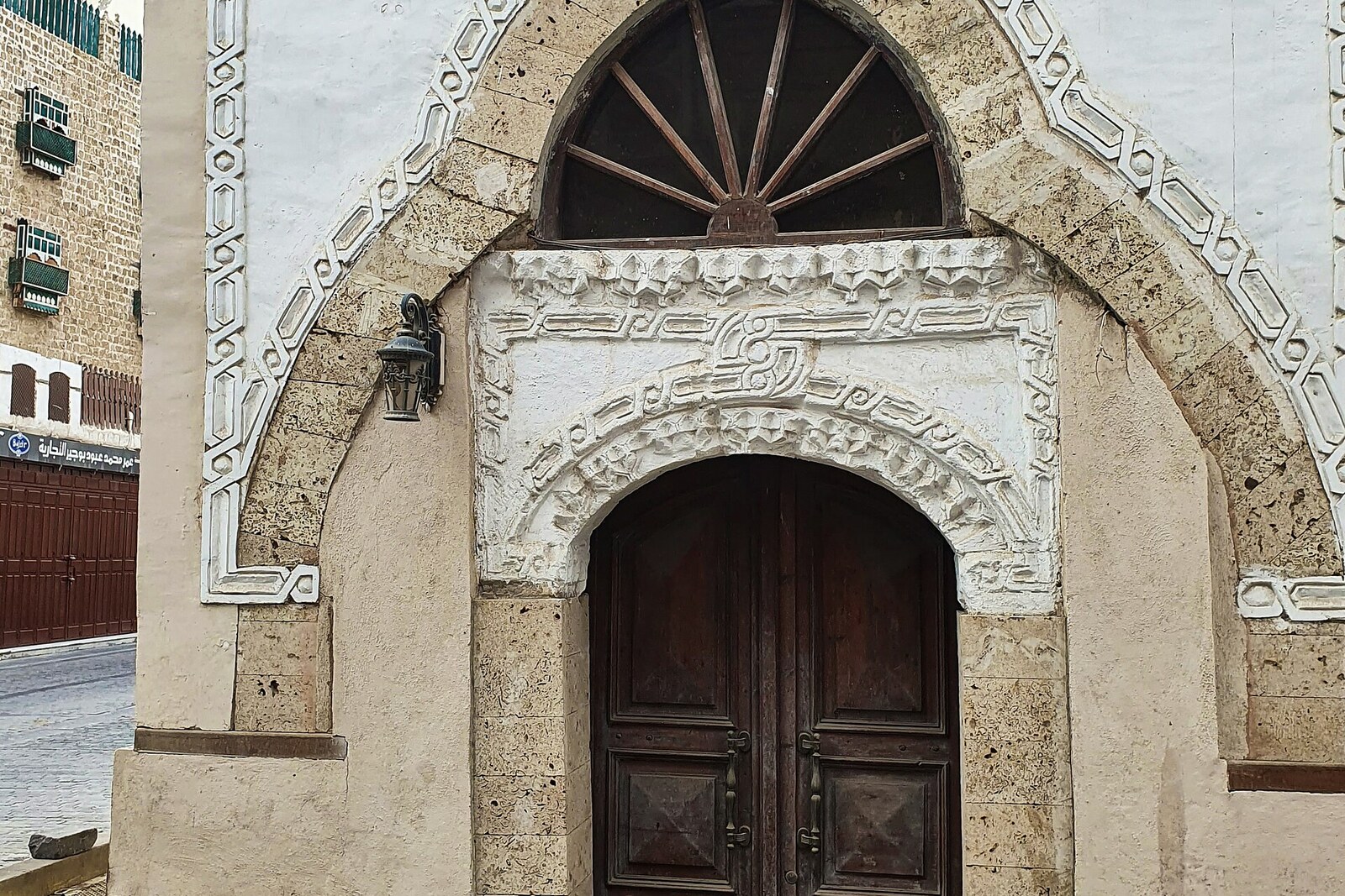 The lowered entrance to Al-Shafi'i Mosque among the streets of Al-Balad