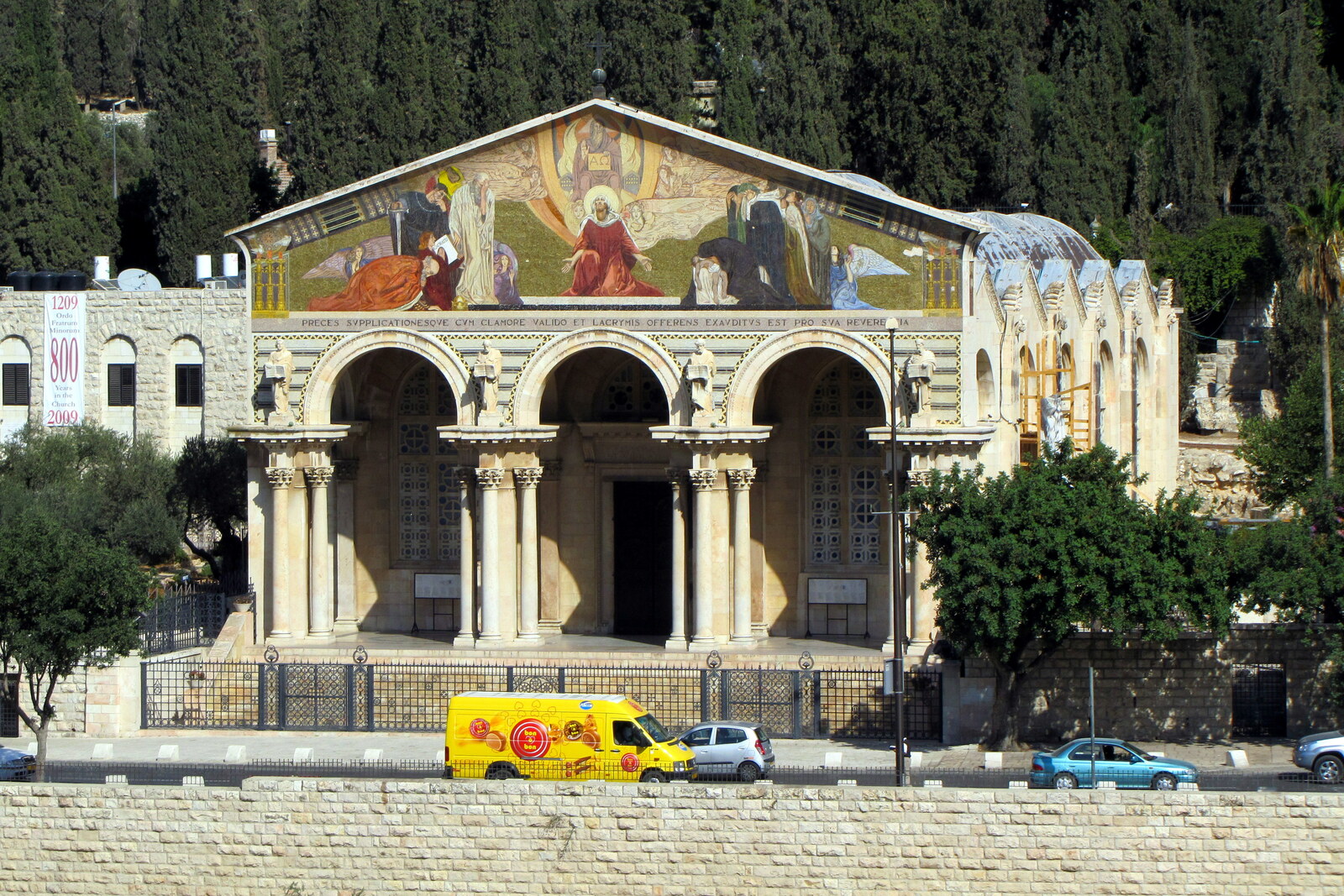 Facade of the Basilica of the Agony with Corinthian columns and a bright mosaic in Jerusalem