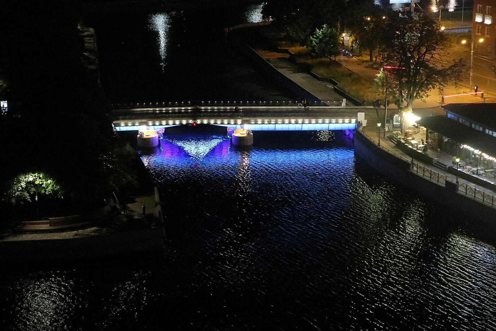 Honey Bridge over the Pregolya and the illuminated facades of Fish Village.
