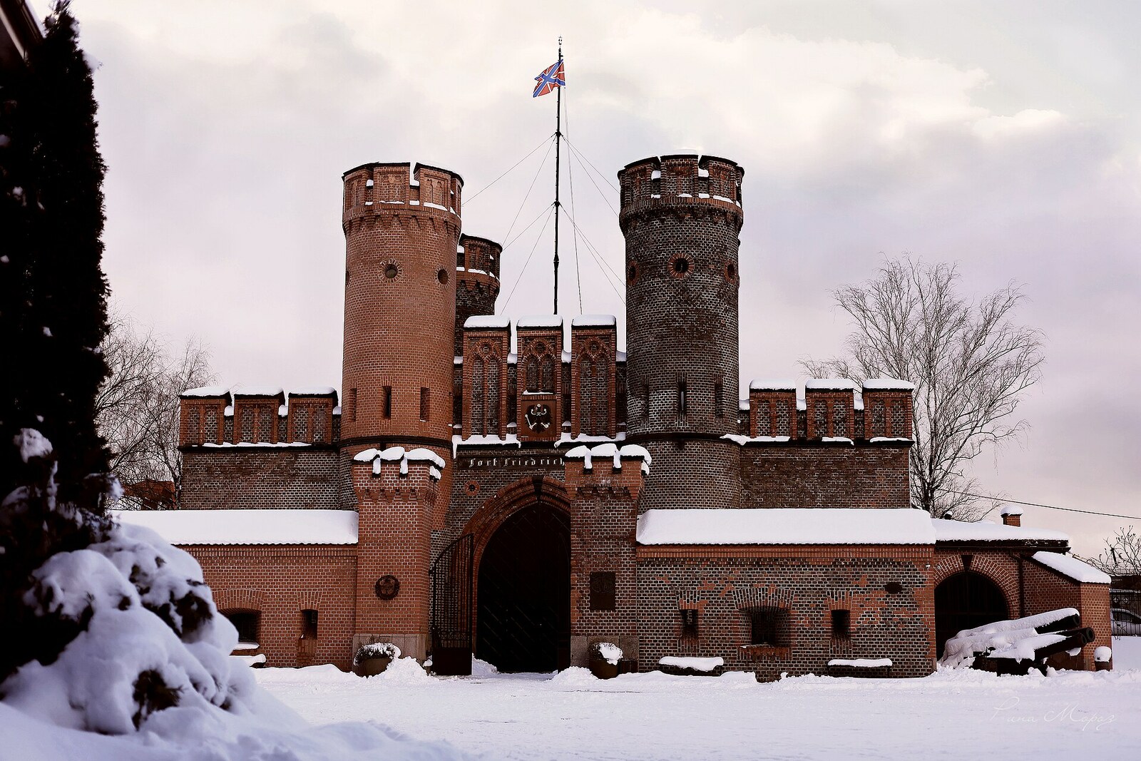 The brick Friedrichsburg Gate with four round towers.