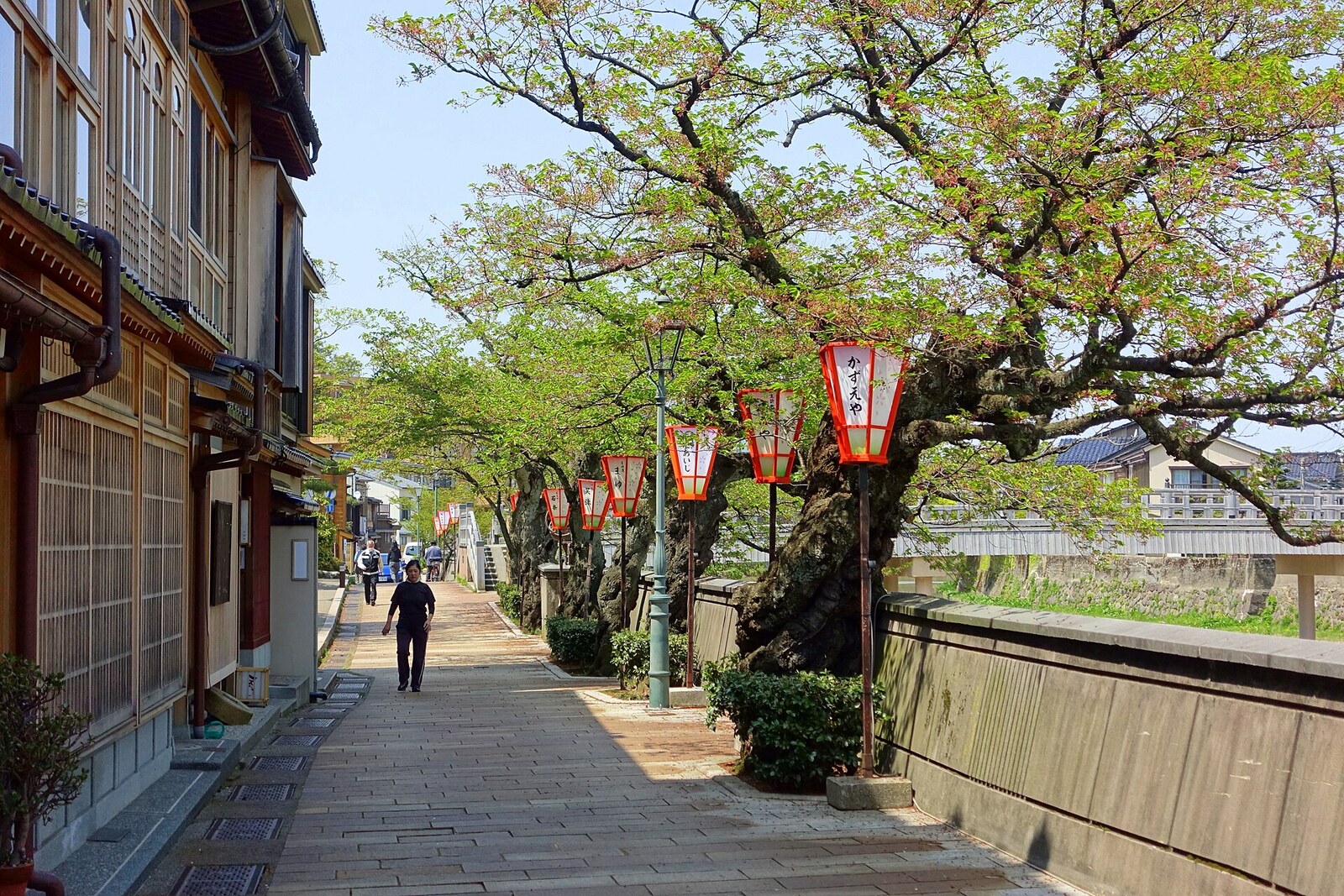 A narrow street in Kazue-machi Chaya District with wooden facades.