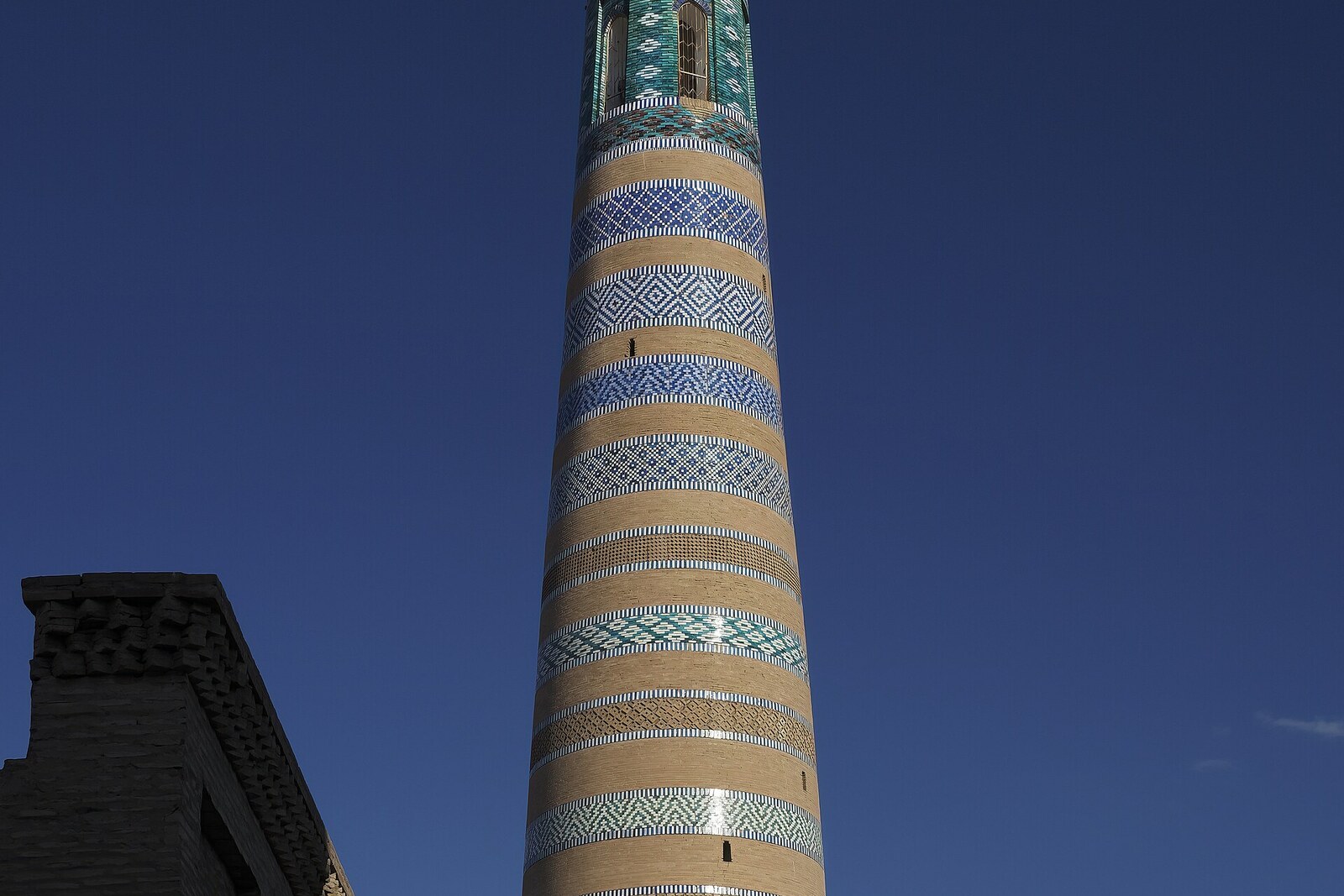The tall tapering Islam Khoja Minaret with turquoise bands.