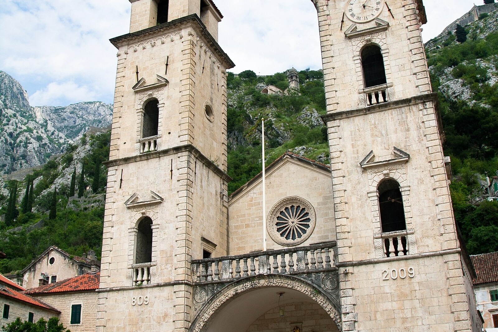 The west façade of St. Tryphon's Cathedral with towers of differing heights.