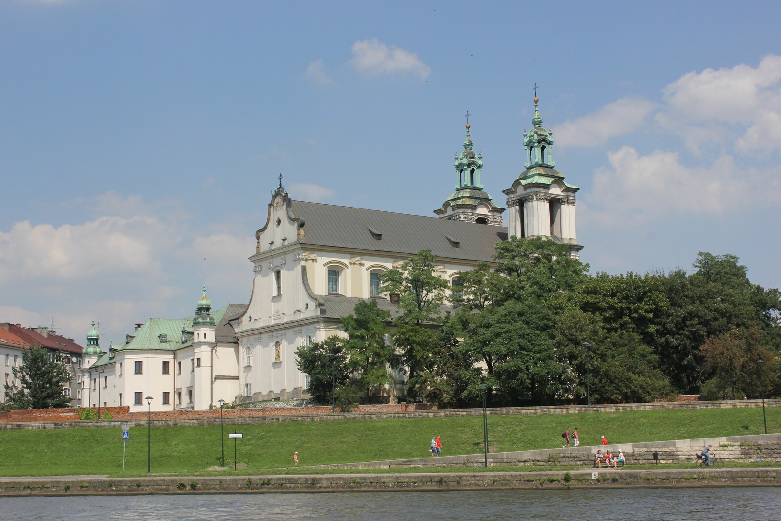 A Baroque church and monastery on a limestone rock with a green dome