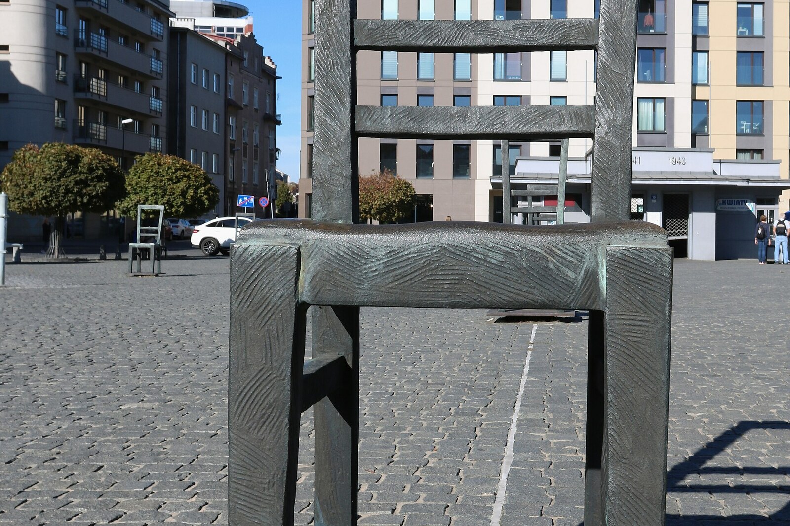 An empty square with a row of metal chairs as a memorial to the ghetto's victims.
