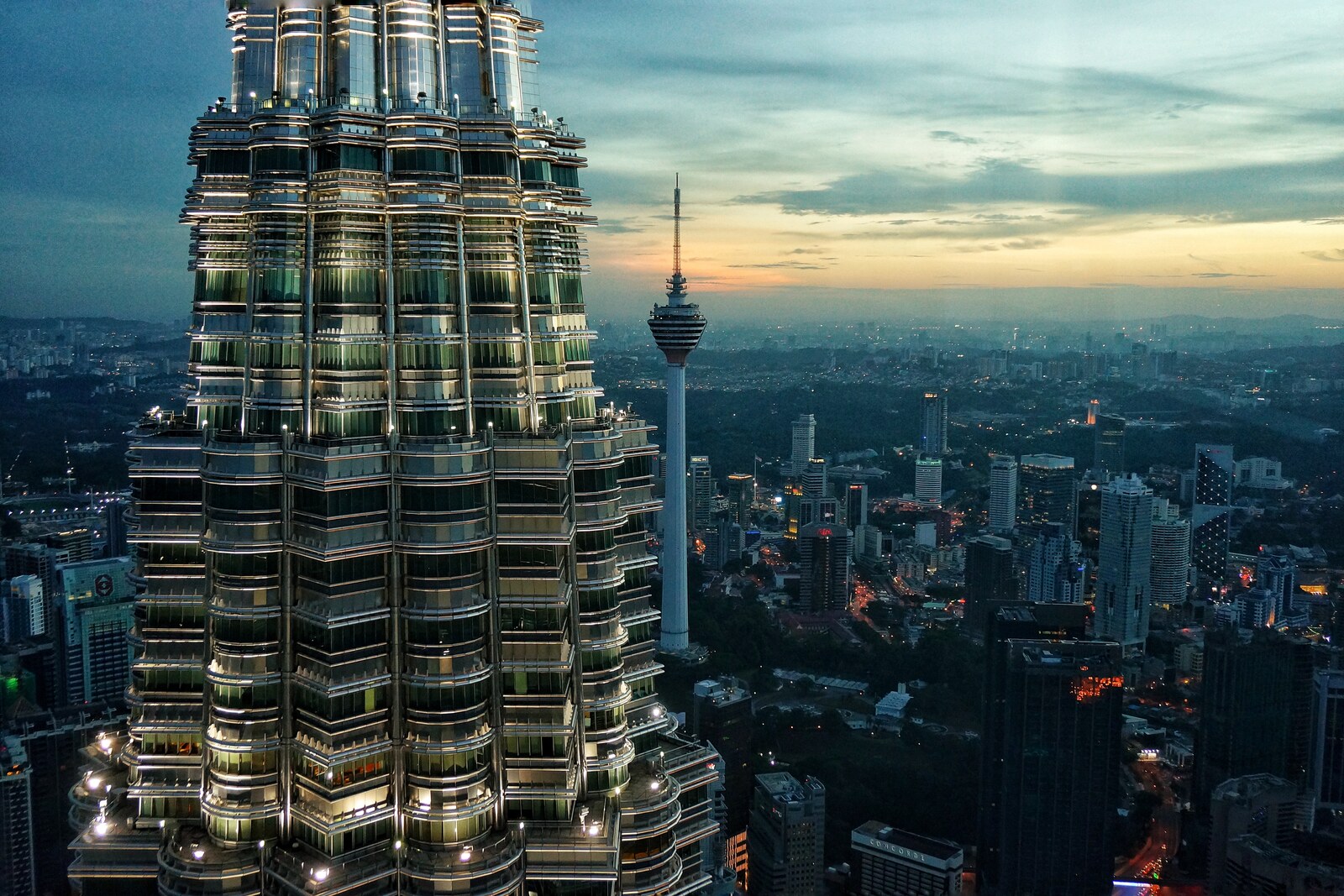 Petronas Twin Towers, two mirrored towers connected by a skybridge.