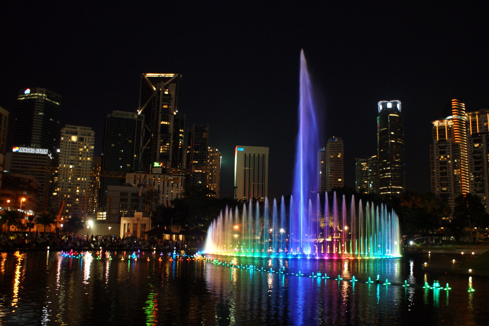 An illuminated musical fountain in front of the towers in central Kuala Lumpur.