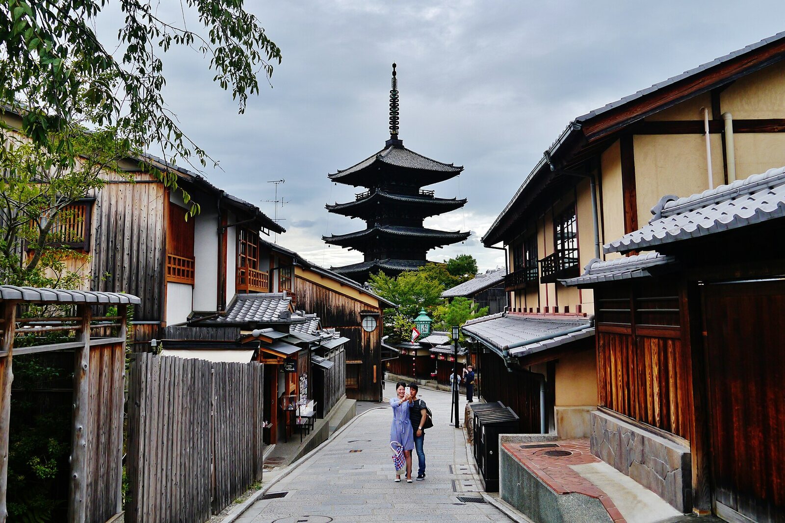 Yasaka Pagoda rises above a wooden street between houses in southern Higashiyama.