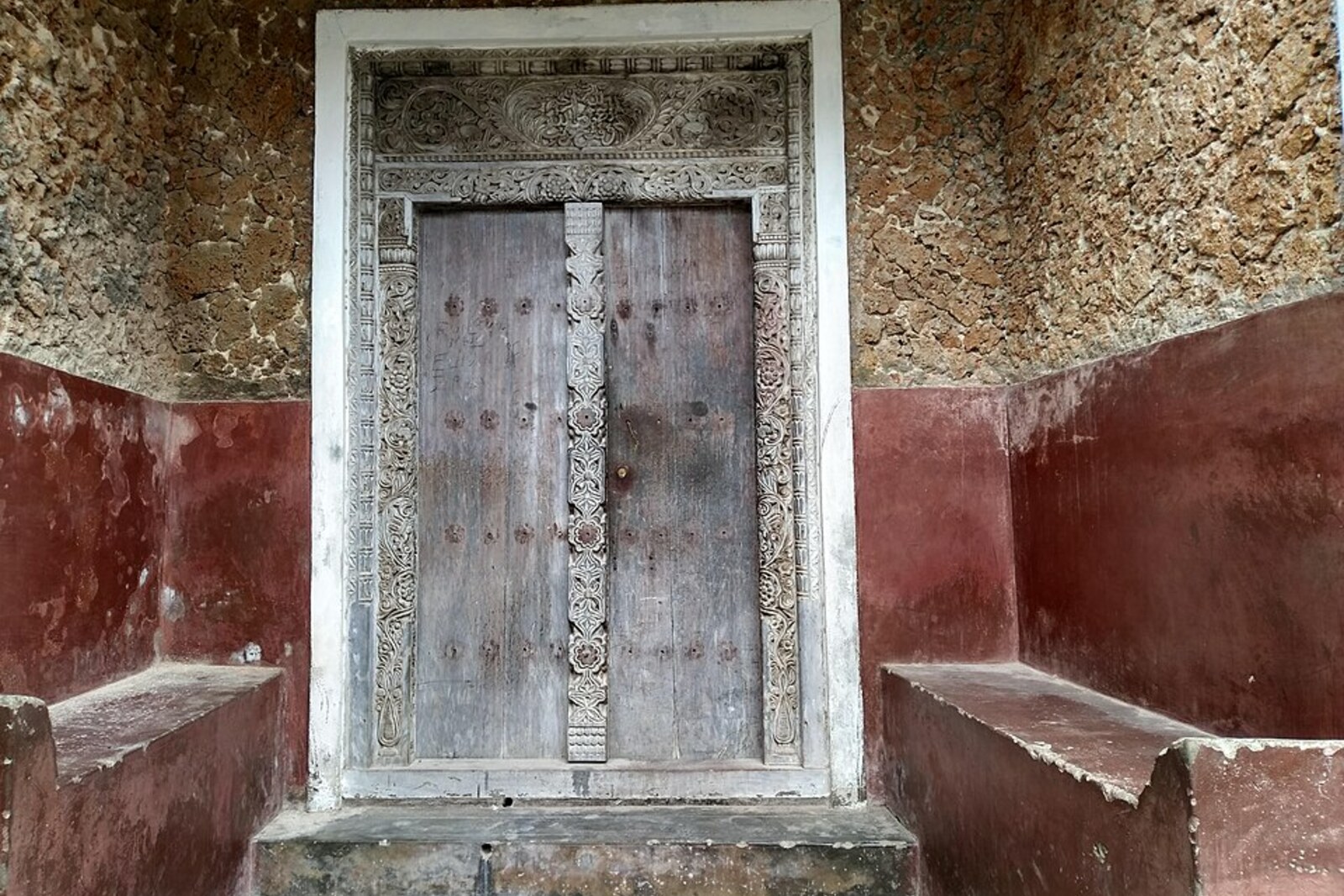 A carved Swahili door frame in Lamu with an Arabic inscription.