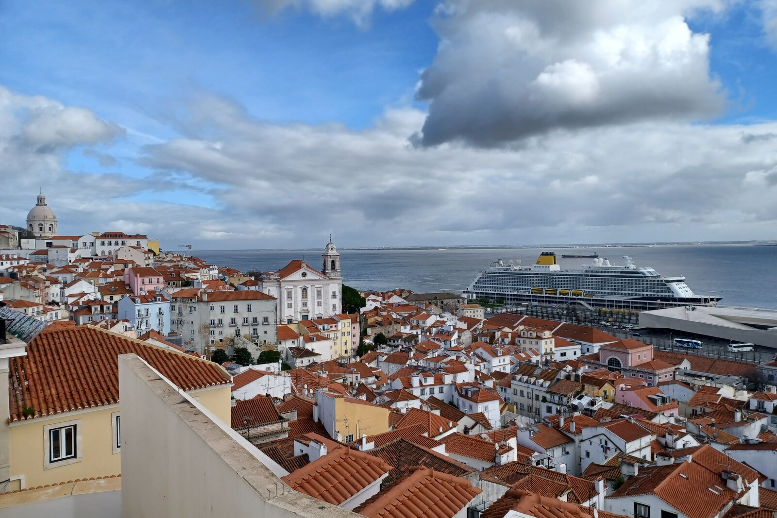 Panoramic view from Miradouro de Santa Luzia, with a colonnade and the city below