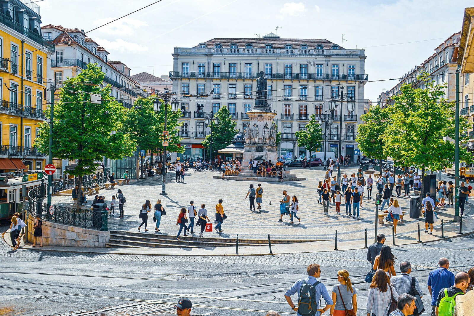 The bronze Monument to Luís de Camões in a spacious square with decorative paving.