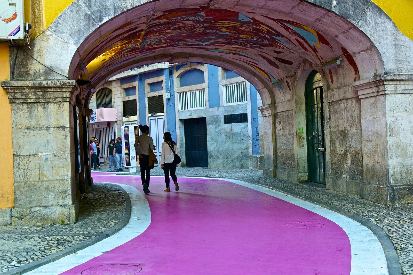 Pink pedestrian street in Cais do Sodré with bars and cafés.
