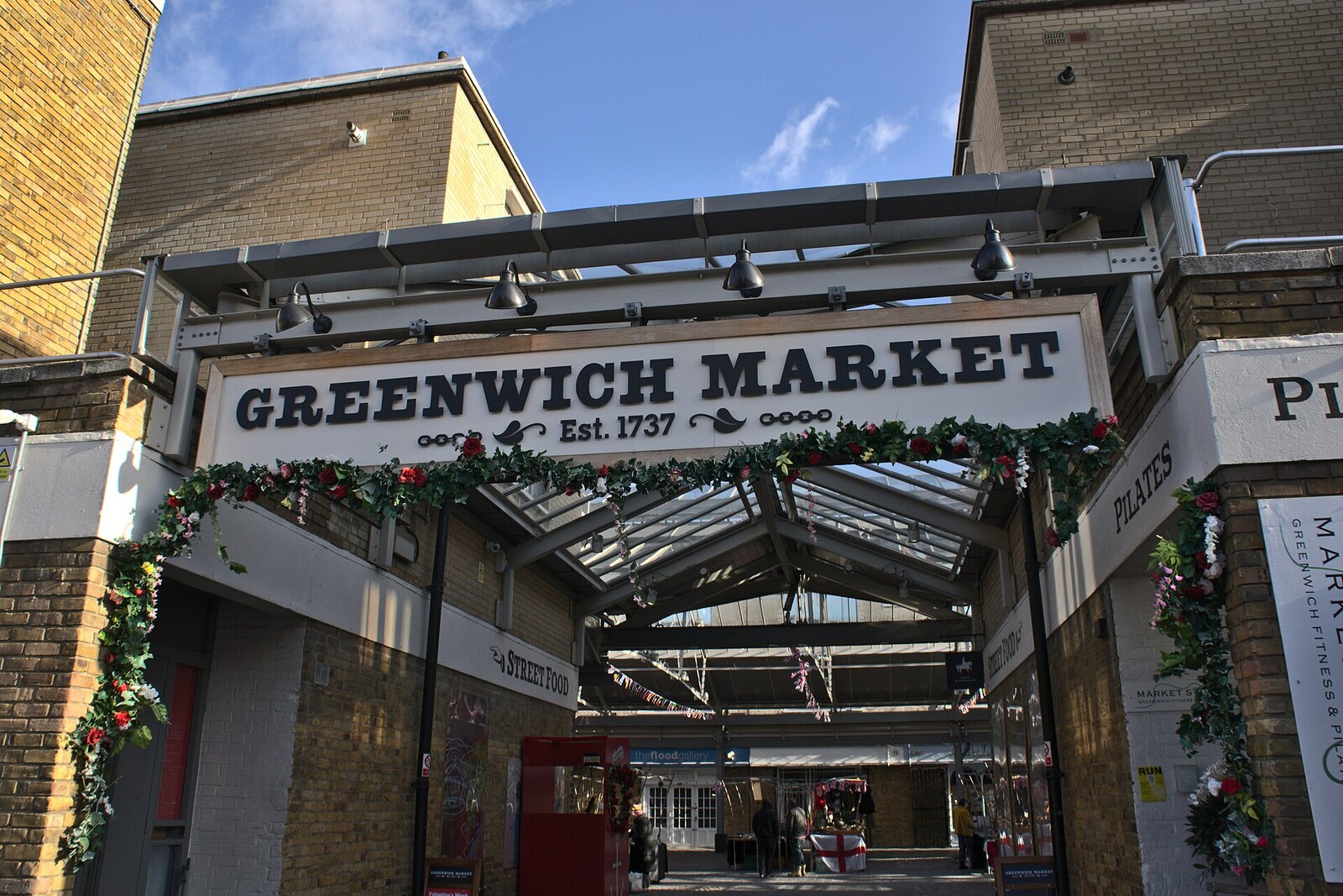 The entrance sign for Greenwich Market, with no close-up view of people.
