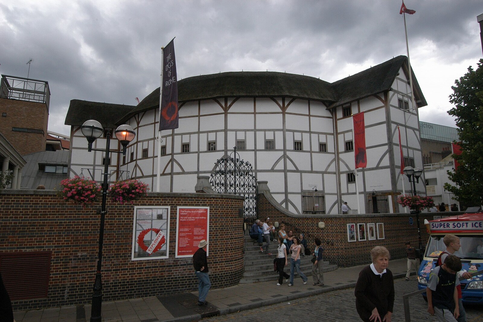 The white wooden building of Shakespeare's Globe theatre, with black beams and a thatched roof