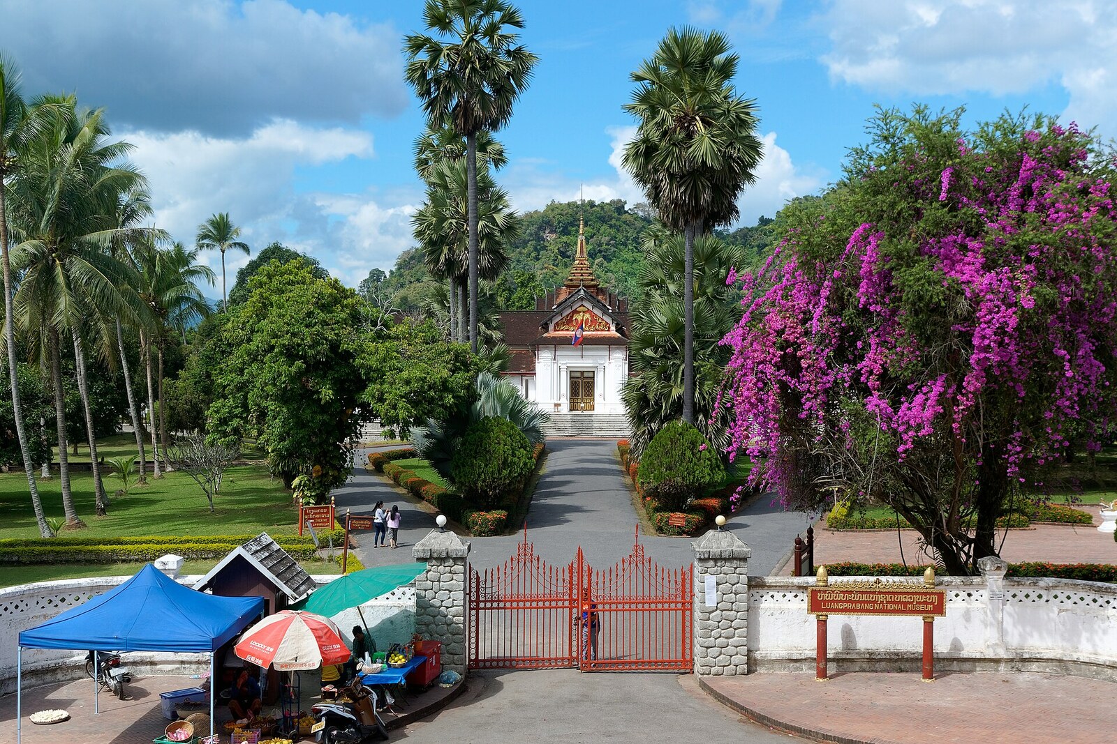 The ceremonial axis of the former Royal Palace (Haw Kham) in Luang Prabang: gates, a garden, and a central structure beneath a Lao roof.