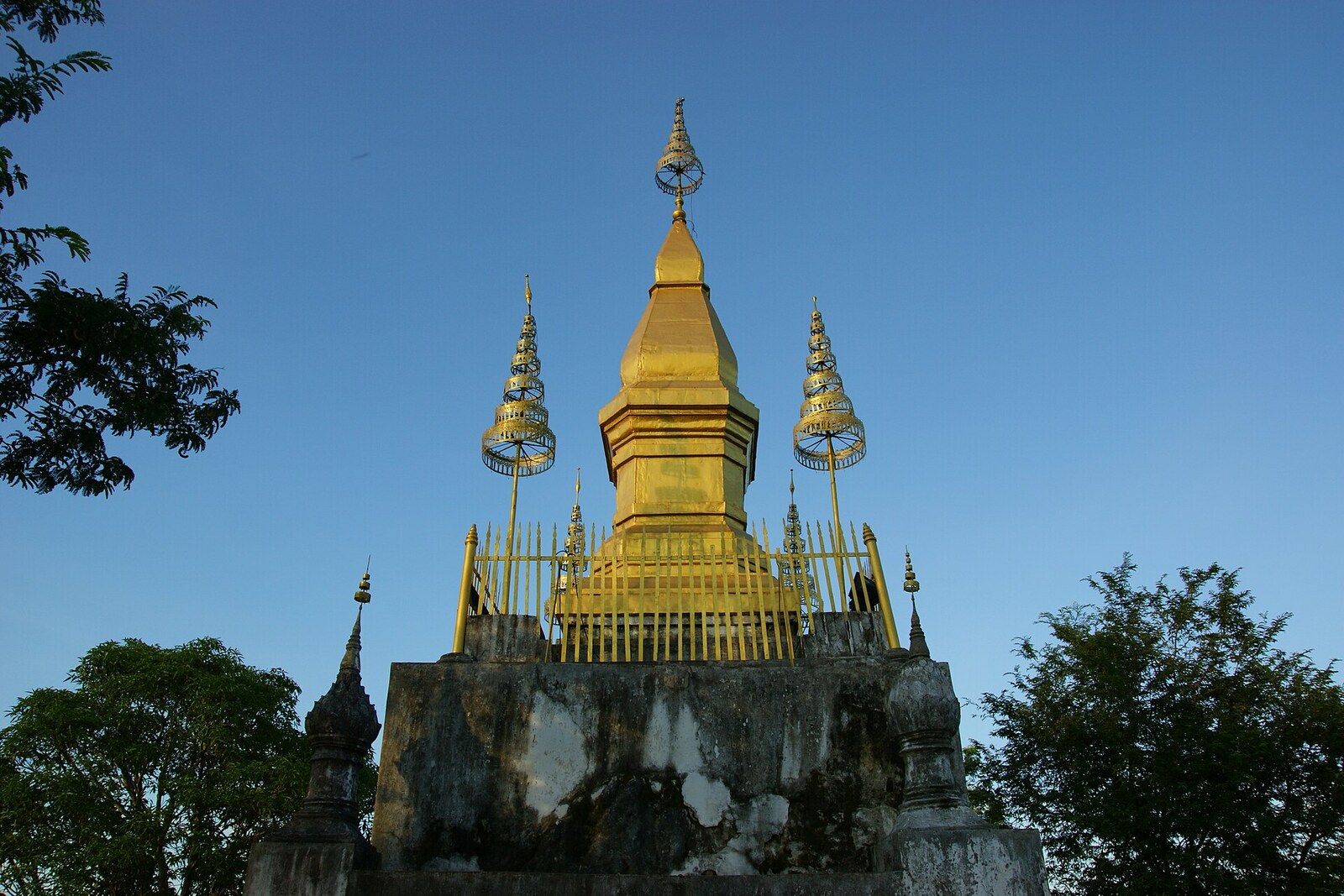 The golden That Chomsi stupa at the summit of Mount Phousi.