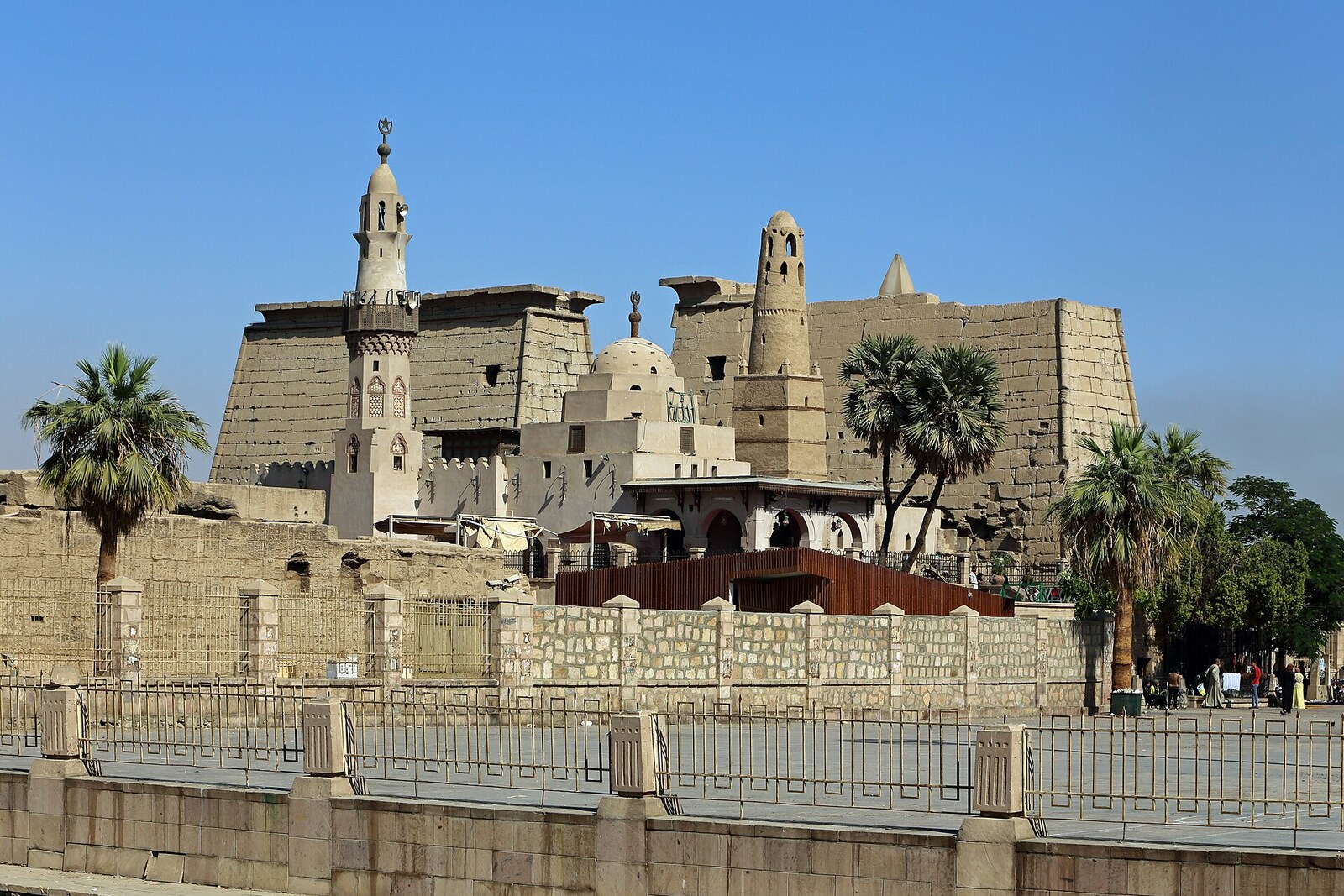 The pylon of Luxor Temple and a mosque above the ancient courtyard.